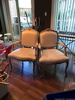 Pair of matching French style armchairs front view