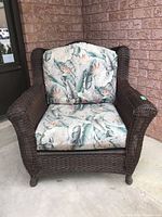 Front view of wicker armchair with cushions