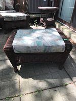 Front angle of wicker ottoman with cushion