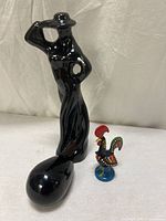 All three items: ceramic abstract woman, black stone, Portuguese rooster