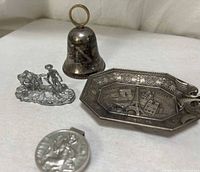 Group shot of all four silver-tone miniatures