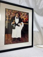 Full view of framed Guy Buffet print under glass