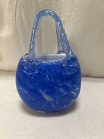 Full view of cobalt blue art glass basket with handle