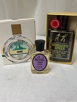 All three fragrance bottles with two in boxes displayed front