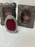 Front view of all three miniature silver-tone frames