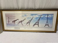 Full view of framed print showing giraffes to Eiffel Tower progression