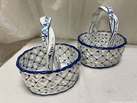 Both ceramic baskets side by side showing lattice design and handles