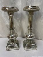 Front view of both mercury glass candle holders