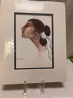 Full view of matted R.C. Gorman print on stand