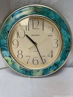 Front view showing entire clock, marbled trim, numerals