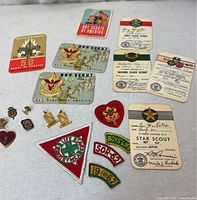 All items laid out including cards, pins and patches