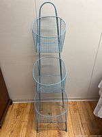 Full view of 3-tier wire basket stand front angle