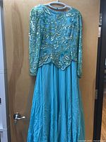 Full view hanging gown showing beaded bodice and skirt