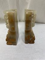 Side view of both onyx bookends showing veining and shape