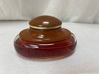 Side view of Obsession bottle showing cap and fill level