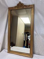 Full view of gold framed rectangular mirror