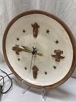 Front view of round ceramic wall clock with cord