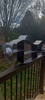 Full view of airplane-shaped shelf showing matte black shelves and silver propeller