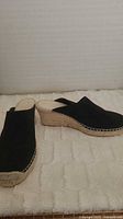 Pair of Costa black suede wedge mule espadrilles side angle