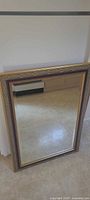 Front view of rectangular mirror with wood frame