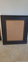 Front view of framed burlap push-pin board