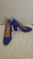 Pair of cobalt blue block heel pumps angled view
