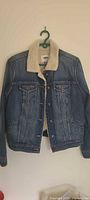 Front view of Old Navy sherpa-lined denim jacket on hanger