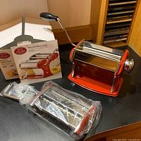 Machine body, cutter attachment in plastic, hand crank, instruction sheet, box insert