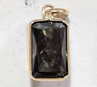 Front view of rectangular moissanite pendant in gold bezel