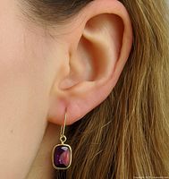 Earring worn on ear showing size and color