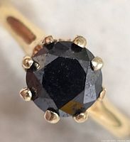 Top view of ring showing black diamond and prongs