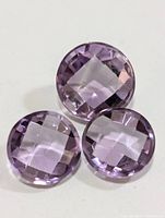 Three round faceted amethyst gemstones