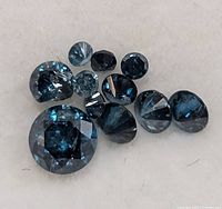 Group of ten blue round diamonds on white background