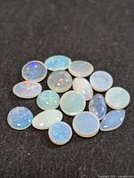 Group of opal cabochons showing shapes and play of colour