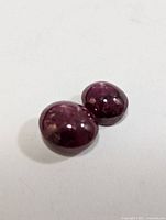Close view of two star ruby cabochons