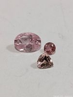 Three pink tourmaline loose stones on white background