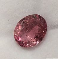 Close-up of oval pink tourmaline on white background