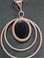Front view showing oval black onyx and concentric silver rings