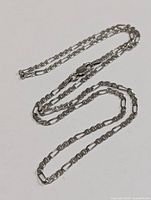 Full view of silver figaro chain necklace