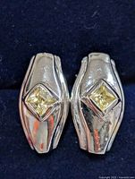 front view of both silver earrings showing yellow princess-cut CZ stones