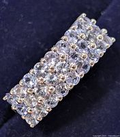 Front view showing three rows of oval-cut tanzanite stones in prong setting