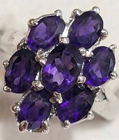 Front view showing seven oval amethysts in silver setting