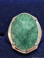 front view showing oval green gemstone in silver setting