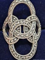 Front view of silver ring showing interlocking oval design