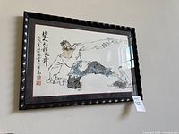 Full view of framed artwork on wall