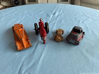 Four vintage toy vehicles lined up