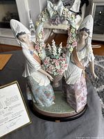 Front view of Lladro Floral Offering figurine on stand showing full piece