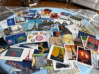 Wide view of assorted postcards and ephemera spread on table