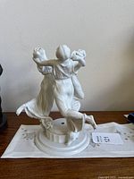 Rear/side view of porcelain group showing three dancing women and central hole