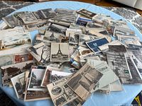 Wide shot of entire spread of vintage Paris postcards on table